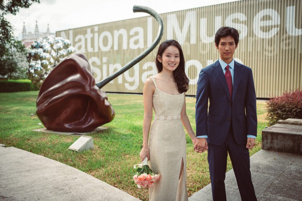 Couple standing in front of an art sculpture.